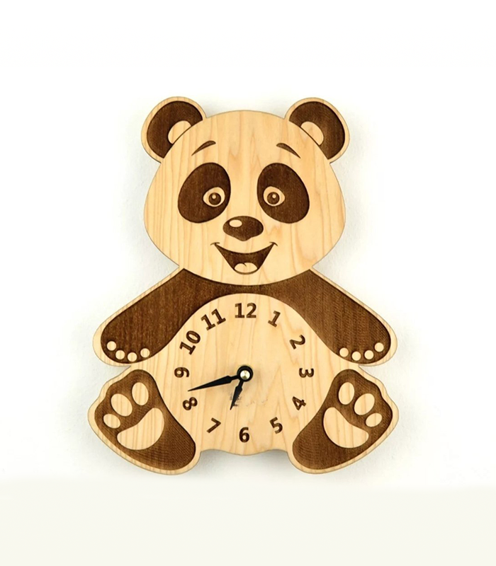 Wooden wall clock shaped like a smiling panda on a white wall